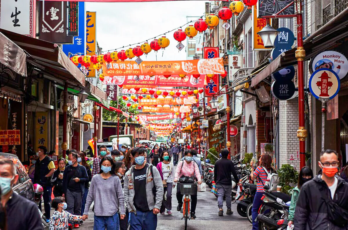Shoppers walk beneath lanterns strung up as people prepare for Chinese New Year at Dihua Street in Taipei, Taiwan on Feb. 10, 2021. (An Rong Xu/Getty Images)