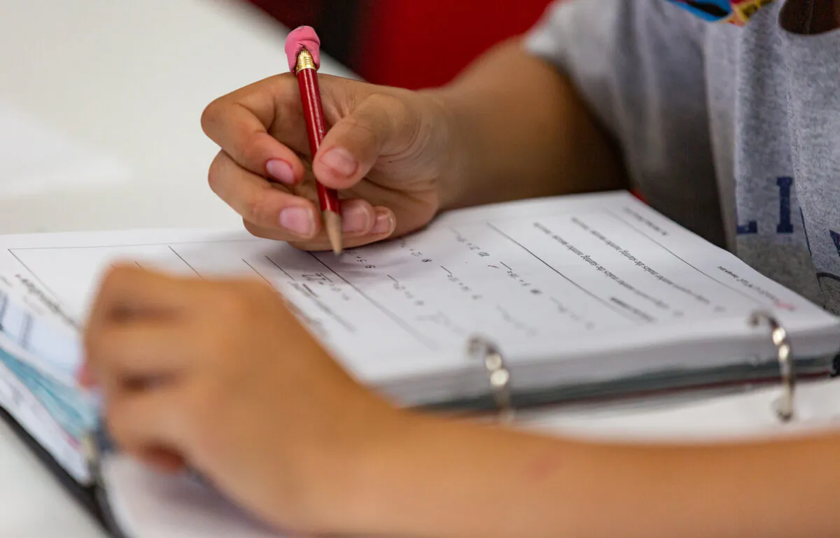 A child works with a math tutor in Laguna Niguel, Calif., on May 12, 2021. (John Fredricks/The Epoch Times)