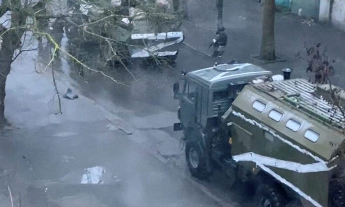 A military truck and tank are seen on a street of Kherson, Ukraine, on March 1, 2022. (Screenshot via Reuters)