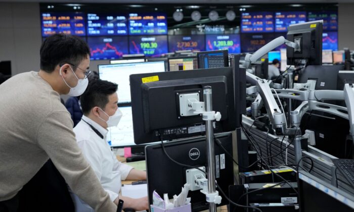 Currency traders watch monitors at the foreign exchange dealing room of the KEB Hana Bank headquarters in Seoul, South Korea, on March 3, 2022. (Ahn Young-joon/AP Photo)