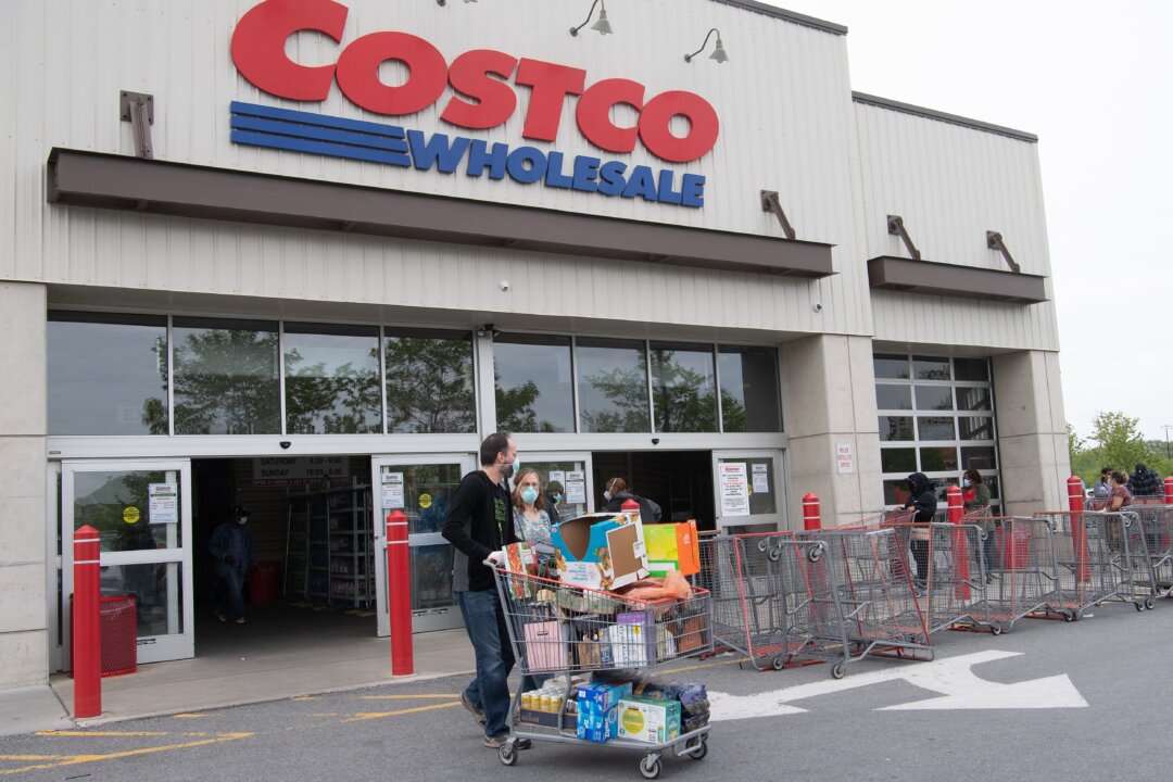 Shoppers walk out with full carts from a Costco store in Washington on May 5, 2020. (Nicholas Kamm/AFP via Getty Images)
