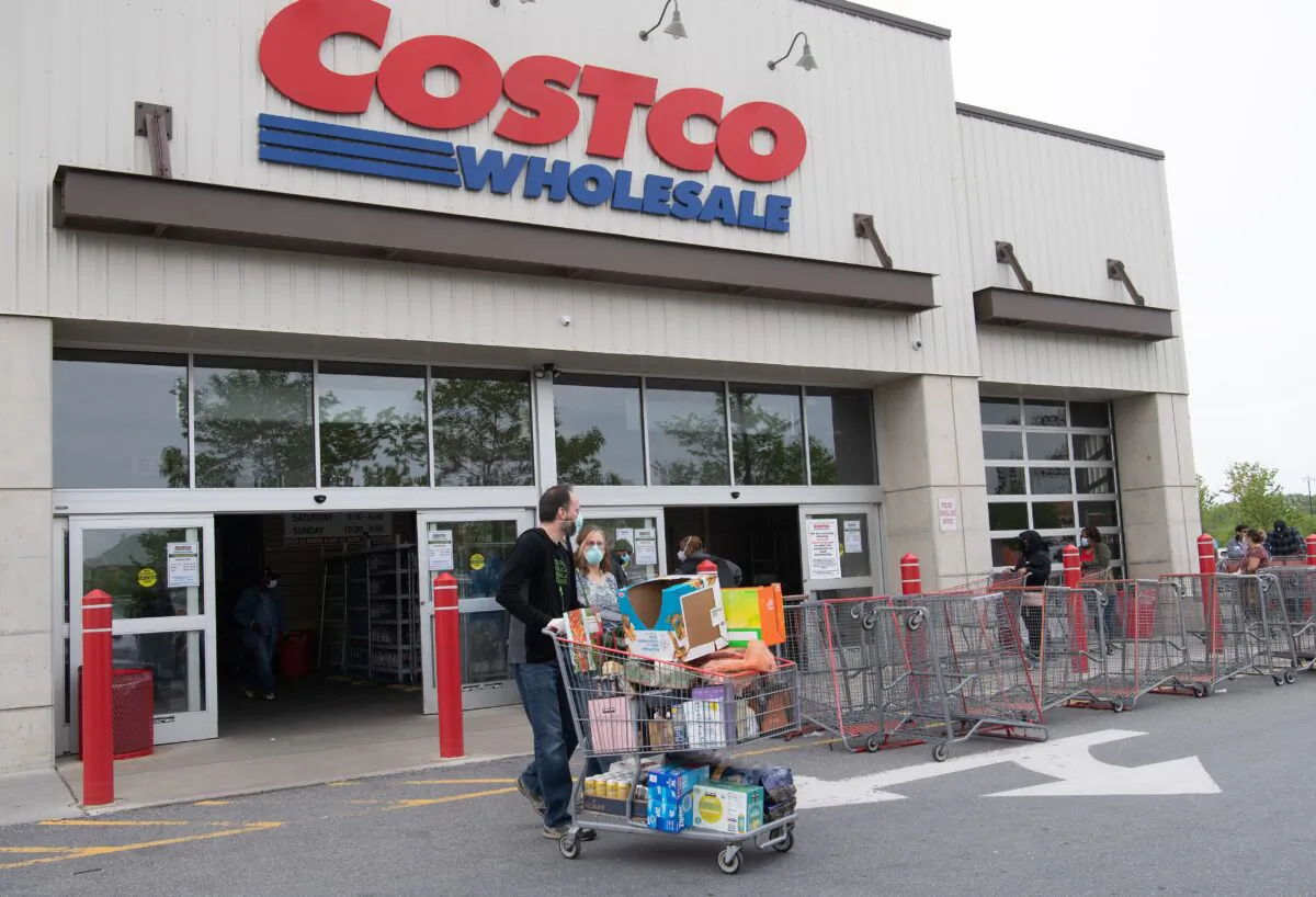 Shoppers walk out with full carts from a Costco store in Washington, on May 5, 2020. (Nicholas Kamm/AFP via Getty Images)