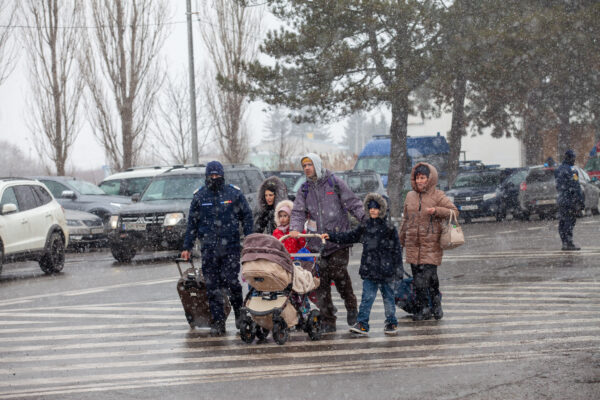 A Ukrainian family makes their way to the boarder between Ukraine and Romania in an effort to escape the city after the war began on February 16, 2022.