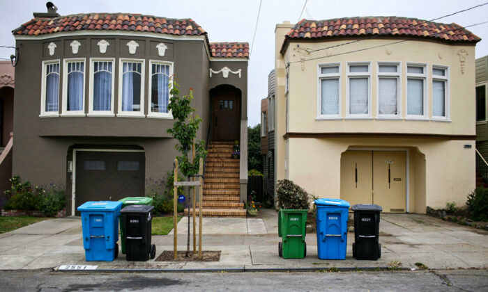 Trash, recycling, and compostable material bins sit in front of homes in a Sunset district neighborhood in San Francisco, Calif., on June 11, 2009. (Justin Sullivan/Getty Images)