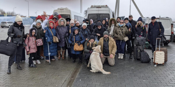 A group of Americans and citizens from other countries pose for one last photo before boarding a bus on the firs leg of their escape from Ukraine after the Russian invasion began February 16, 2022.