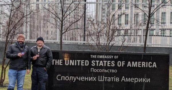 Bryan Stern, co-founder of Project Dynamo, stands in front of the sign for the now shuttered American embassy in Kiev, Ukraine, following the start of Russia's missile attacks on February 16, 2022.