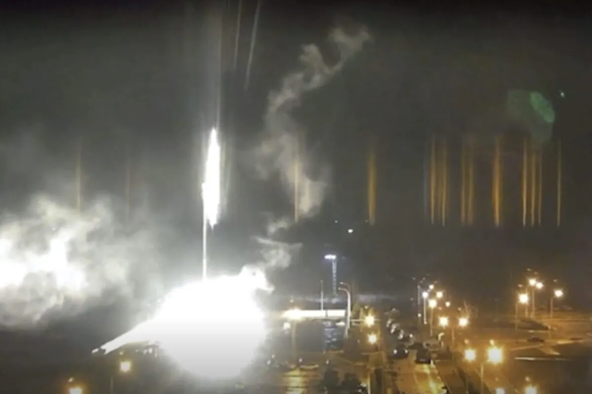 This image made from a video released by Zaporizhzhia nuclear power plant shows bright flaring object landing in grounds of the nuclear plant in Enerhodar, Ukraine Friday, March 4, 2022. (Zaporizhzhia nuclear power plant via AP)