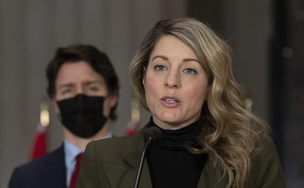 Canadian Prime Minister Justin Trudeau looks on as Foreign Affairs Minister Melanie Joly responds to a question during a news conference, Feb. 24, 2022 in Ottawa. (The Canadian Press/Adrian Wyld)