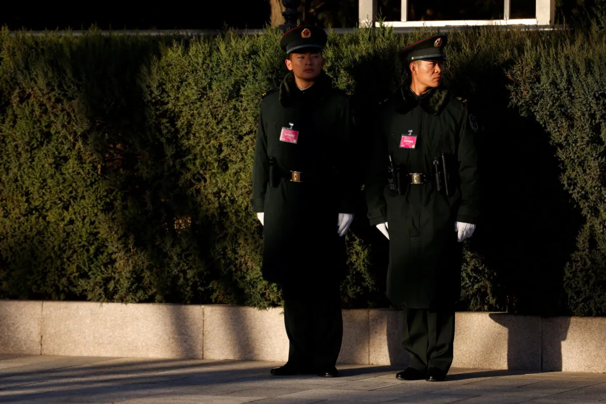 Chinese soldiers stand guard in Beijing, China, on March 5, 2022. (Carlos Garcia Rawlins/Reuters)