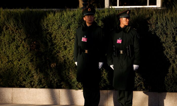 Chinese soldiers stand guard in Beijing, China, on March 5, 2022. (Carlos Garcia Rawlins/Reuters)