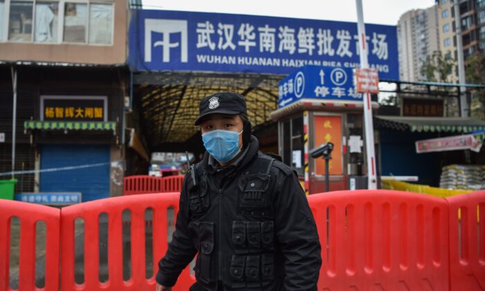 A police officer stands guard outside of Huanan Seafood Wholesale market, where vendors were infected with SARS-CoV-2, was detected in Wuhan, China on Jan. 24, 2020. (Hector Retamal/AFP via Getty Images)