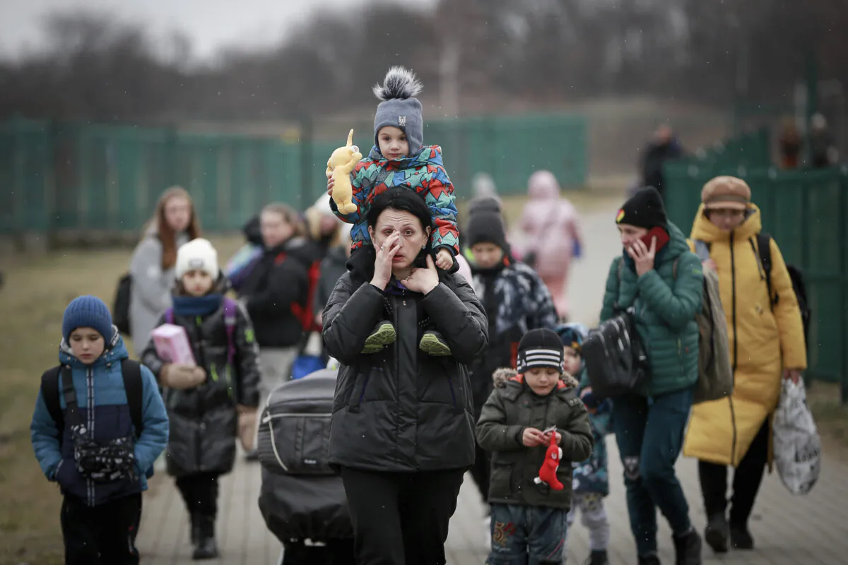 Refugees, mostly women with children, arrive at the border crossing in Medyka, Poland, on March 5, 2022. (AP Photo/Visar Kryeziu)