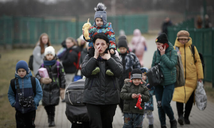 Refugees, mostly women with children, arrive at the border crossing in Medyka, Poland, on March 5, 2022. (AP Photo/Visar Kryeziu)