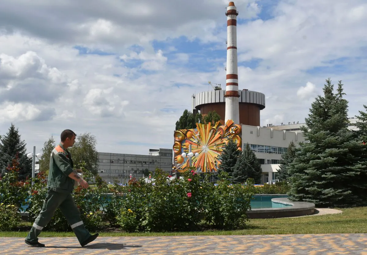 People walk in front of Yuzhnoukrainska Nuclear Power Plant on June 19, 2018. (Genya Savilov/AFP via Getty Images)
