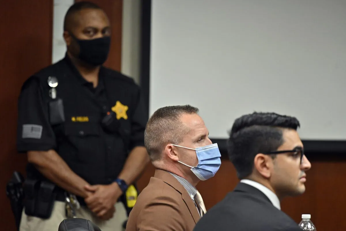 Former Louisville Police Officer Brett Hankison, center, awaits the jury's verdict in his wanton endangerment trial in Louisville, Ky., on March 3, 2022. (Timothy D. Easley/Pool/AP Photo)