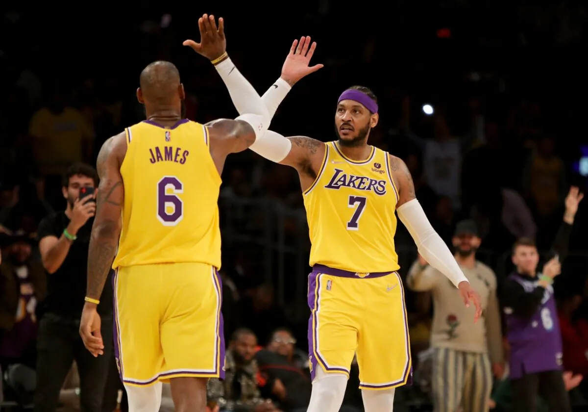 Los Angeles Lakers forward Carmelo Anthony (7) high-fives forward LeBron James (6) after Anthony made a three point basket in the fourth quarter against the Golden State Warriors at Crypto.com Arena in Los Angeles on March 5, 2022. (Kiyoshi Mio/USA TODAY Sports via Field Level Media)