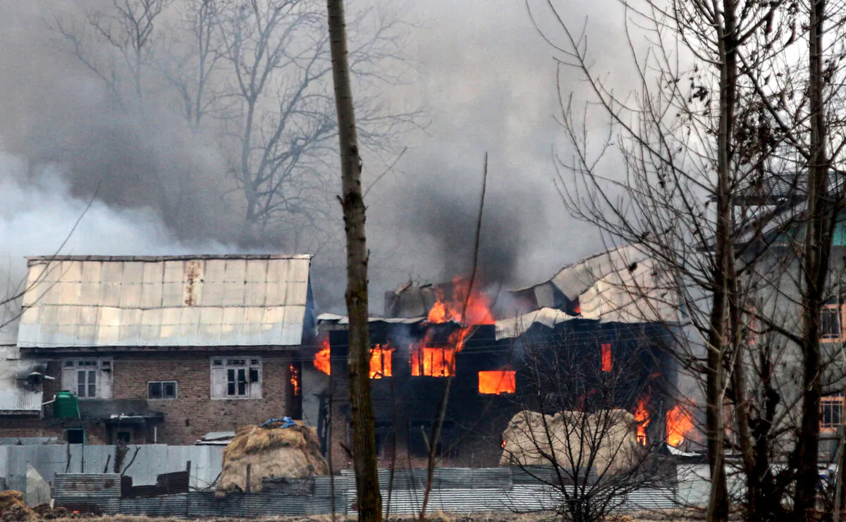 A house in which militants are suspected to have sheltered is in flames after a gunfight happened between rebels and Indian security forces that killed four soldiers, in South Kashmir's Pulwama district, about 10 kilometers away from the spot of recent suicide bombing, on Feb. 18, 2019. An investigator has pointed out that MBBS seats sold to Kashmiri students in Pakistan are being used to fund terror activities. (STR/AFP via Getty Images)