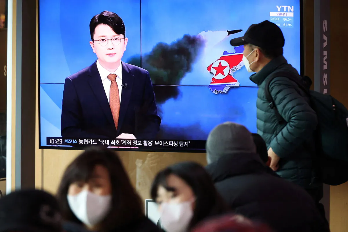 People watch a TV broadcasting a news report on North Korea's firing a ballistic missile off its east coast, in Seoul, South Korea, on March 5, 2022. (Kim Hong-Ji/Reuters)