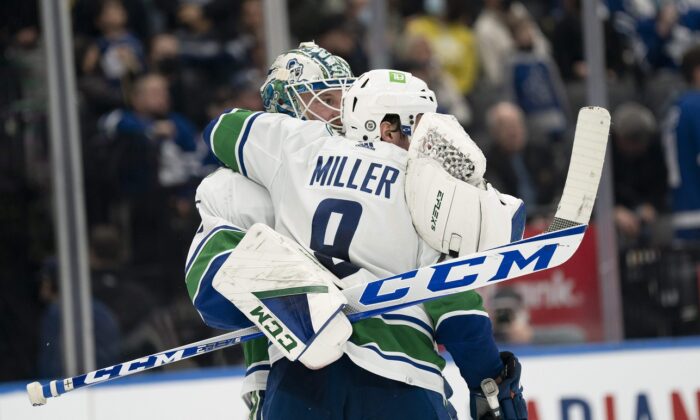 Vancouver Canucks goaltender Thatcher Demko (35) celebrates the win with center J.T. Miller (9) at the end of the third period against the Toronto Maple Leafs at Scotiabank Arena in Toronto on March 5, 2022. (Nick Turchiaro/USA TODAY Sports via Field Level Media)
