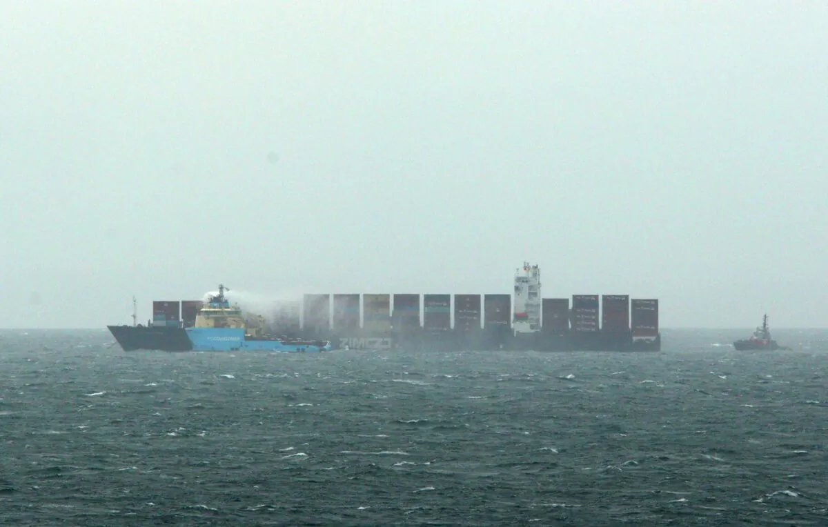 Ships work to control a fire onboard the MV Zim Kingston about eight kilometres from the shore in Victoria, B.C., on October 25, 2021. (The Canadian Press/Chad Hipolito)