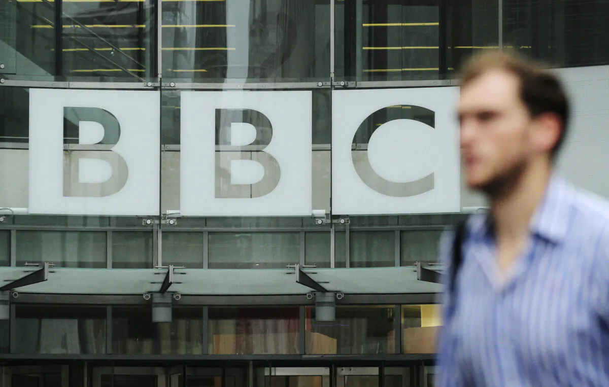 A pedestrian walks past a BBC logo at Broadcasting House in central London on Oct. 22, 2012. (Olivia Harris/Reuters)