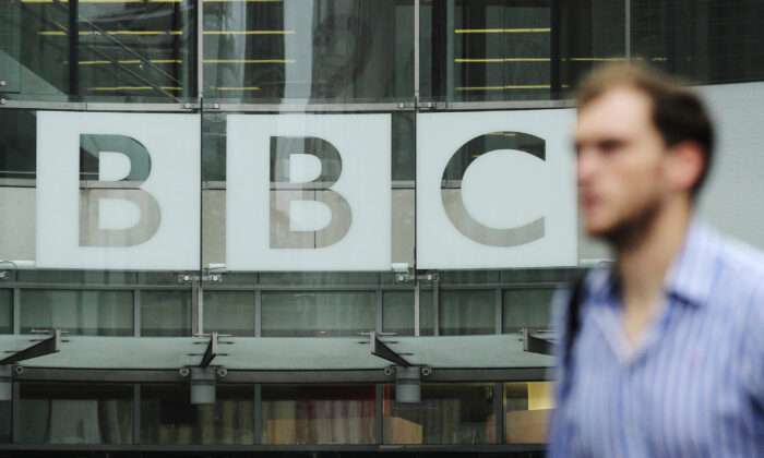 A pedestrian walks past a BBC logo at Broadcasting House in central London on Oct. 22, 2012. (Olivia Harris/Reuters)