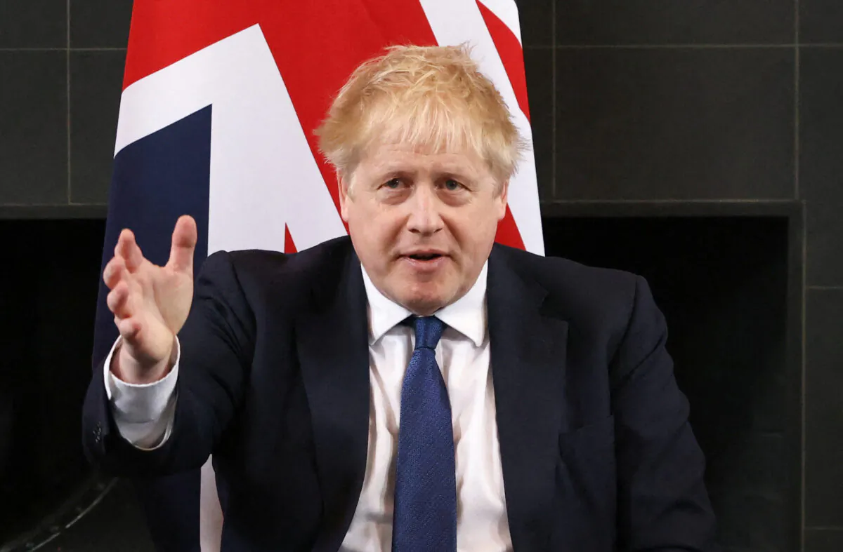 British Prime Minister Boris Johnson gestures as he speaks at the Royal Air Force base in Northolt, near London, on March 7, 2022. (Henry Nicholls/Pool/AFP via Getty Images)