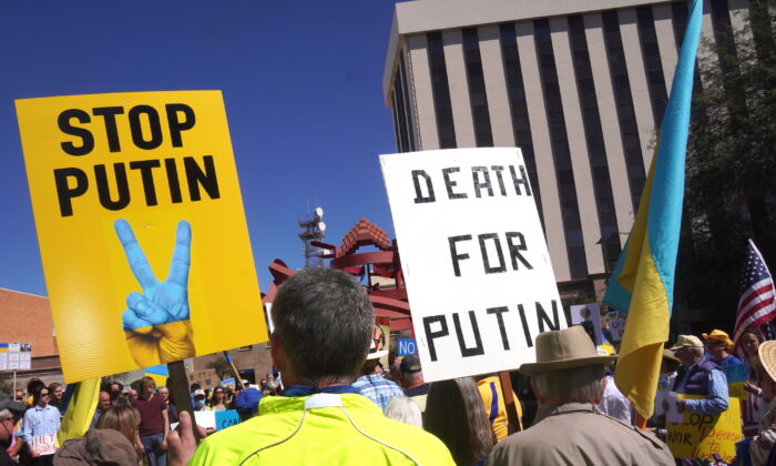 Protesters carry signs against the Russian invasion of Ukraine and Russian President Vladimir Putin during a rally in Tucson, Ariz., on March 6, 2022. (Allan Stein/The Epoch Times)