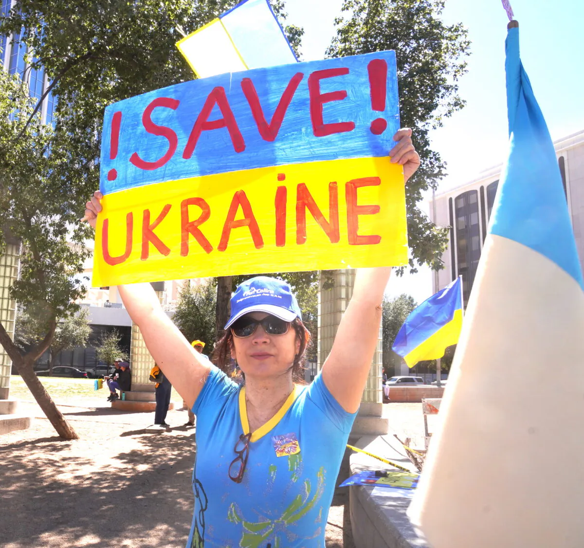 Ayna Kekilova of Tucson hold a sign in support of her native Ukraine during an anti-war rally in Tucson, Ariz., on March 6. (Allan Stein/The Epoch Times)