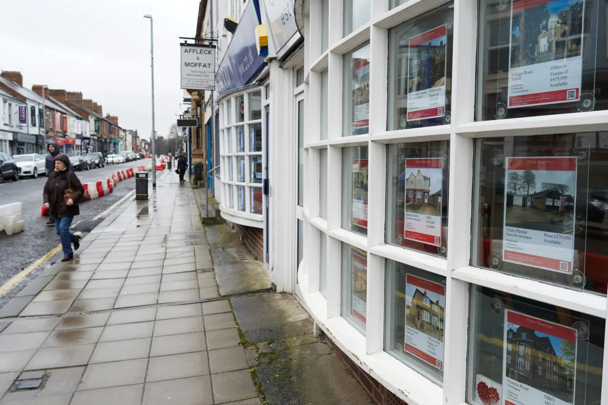 A woman walks past an estate agents window in Darlington, England on March 04, 2021. (Ian Forsyth/Getty Images)