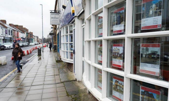 A woman walks past an estate agents window in Darlington, England on March 04, 2021. (Ian Forsyth/Getty Images)