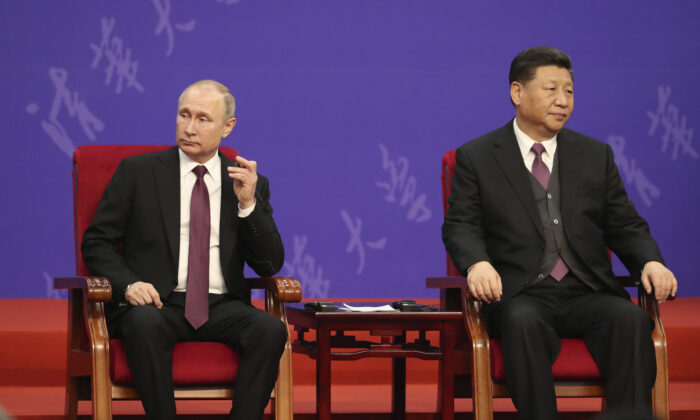 Russian President Vladimir Putin and Chinese leader Xi Jinping (R) attend the Tsinghua University's ceremony at Friendship Palace in Beijing, China, on April 26, 2019. (Kenzaburo Fukuhara/Pool/Getty Images)