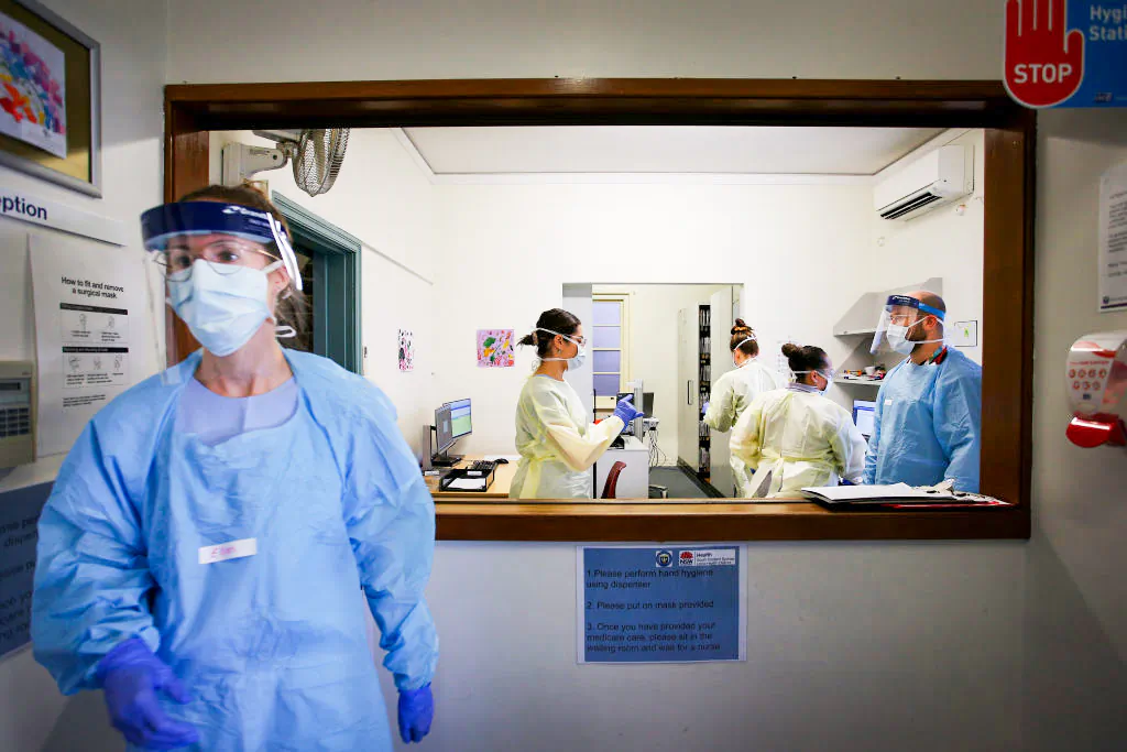 A nurse goes to assist a patient at the COVID-19 and flu assessment clinic at Prince of Wales Hospital in Sydney, Australia, on May 12, 2020. (Lisa Maree Williams/Getty Images)