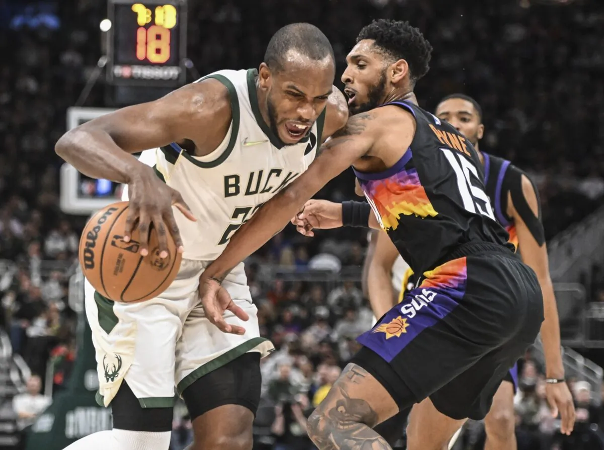 Milwaukee Bucks forward Khris Middleton (22) drives for the basket against Phoenix Suns guard Cameron Payne (15) in the fourth quarter at Fiserv Forum in Milwaukee, Wis., on March 6, 2022. (Benny Sieu/USA TODAY Sports via Field Level Media)
