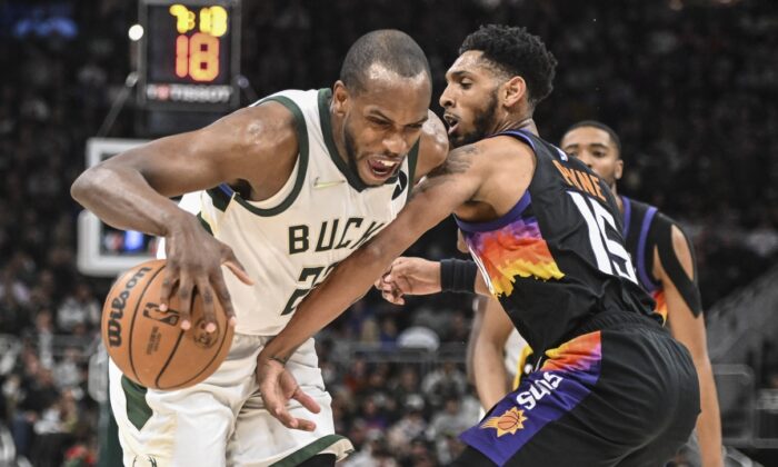 Milwaukee Bucks forward Khris Middleton (22) drives for the basket against Phoenix Suns guard Cameron Payne (15) in the fourth quarter at Fiserv Forum in Milwaukee, Wis., on March 6, 2022. (Benny Sieu/USA TODAY Sports via Field Level Media)
