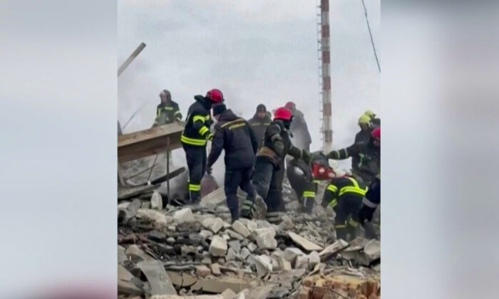 Emergency services personnel work following a missile strike on the Vinnytsia International Airport building in Vinnytsia, Ukraine, on March 6, 2022, in a still from a video. (Courtesy of Serhiy Borzov via Reuters/Screenshot via The Epoch Times)