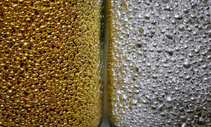 Granules of 99.99 percent pure gold and silver are seen in glass jars at the Krastsvetmet non-ferrous metals plant, one of the world's largest producers in the precious metals industry, in the Siberian city of Krasnoyarsk, Russia, on Nov. 22, 2018. (Ilya Naymushin/Reuters)