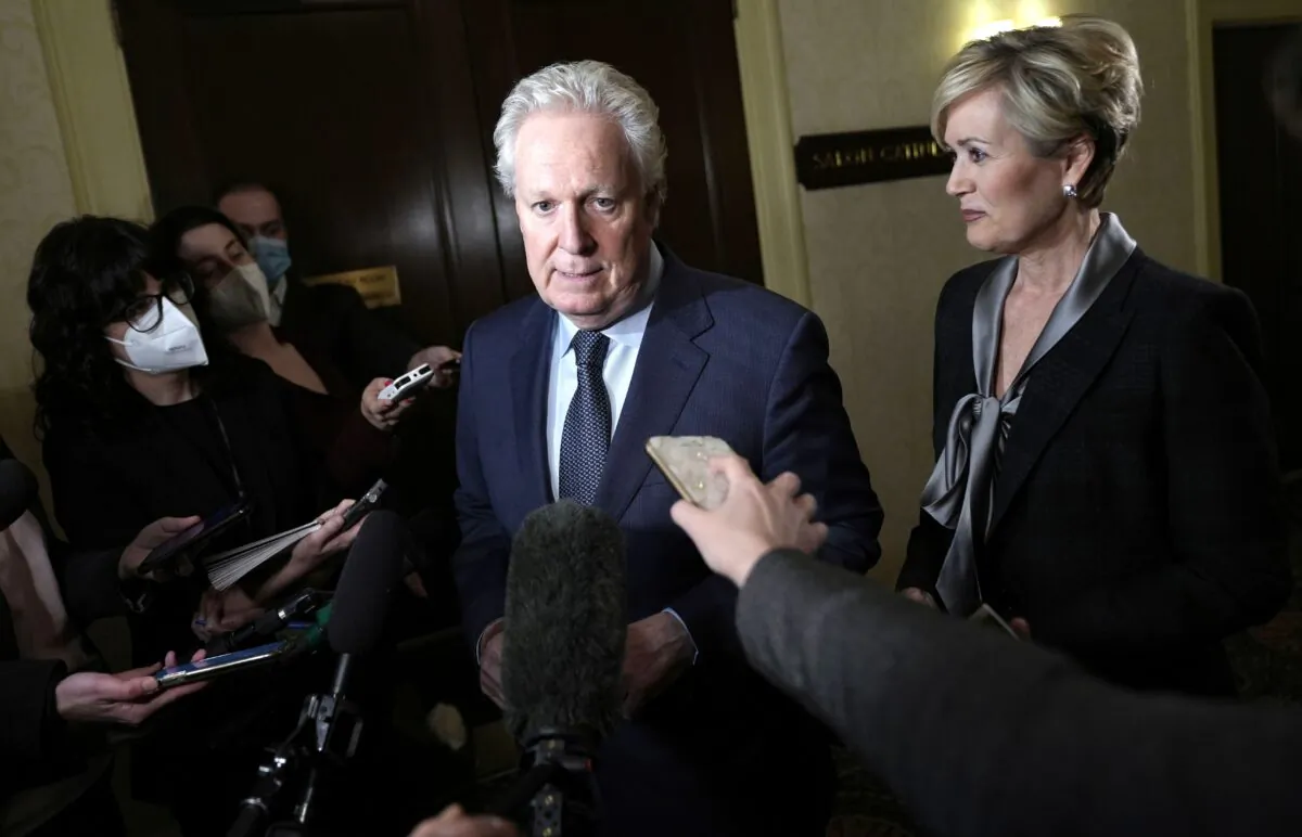 Former Quebec premier Jean Charest speaks to reporters as he arrives with his wife, Michele Dionne, for an event with potential caucus supporters as he considers a run for the leadership of the Conservative Party, in Ottawa on March 2, 2022. (The Canadian Press/Justin Tang)
