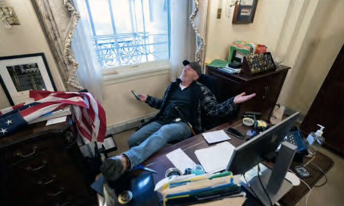 Richard 'Bigo' Barnett poses for photos in the office of House Speaker Nancy Pelosi on Jan. 6, 2021. He would have received roughly six to seven years in prison under a plea offer that his attorney called "ridiculous." (U.S. Department of Justice/Screenshot via The Epoch Times)