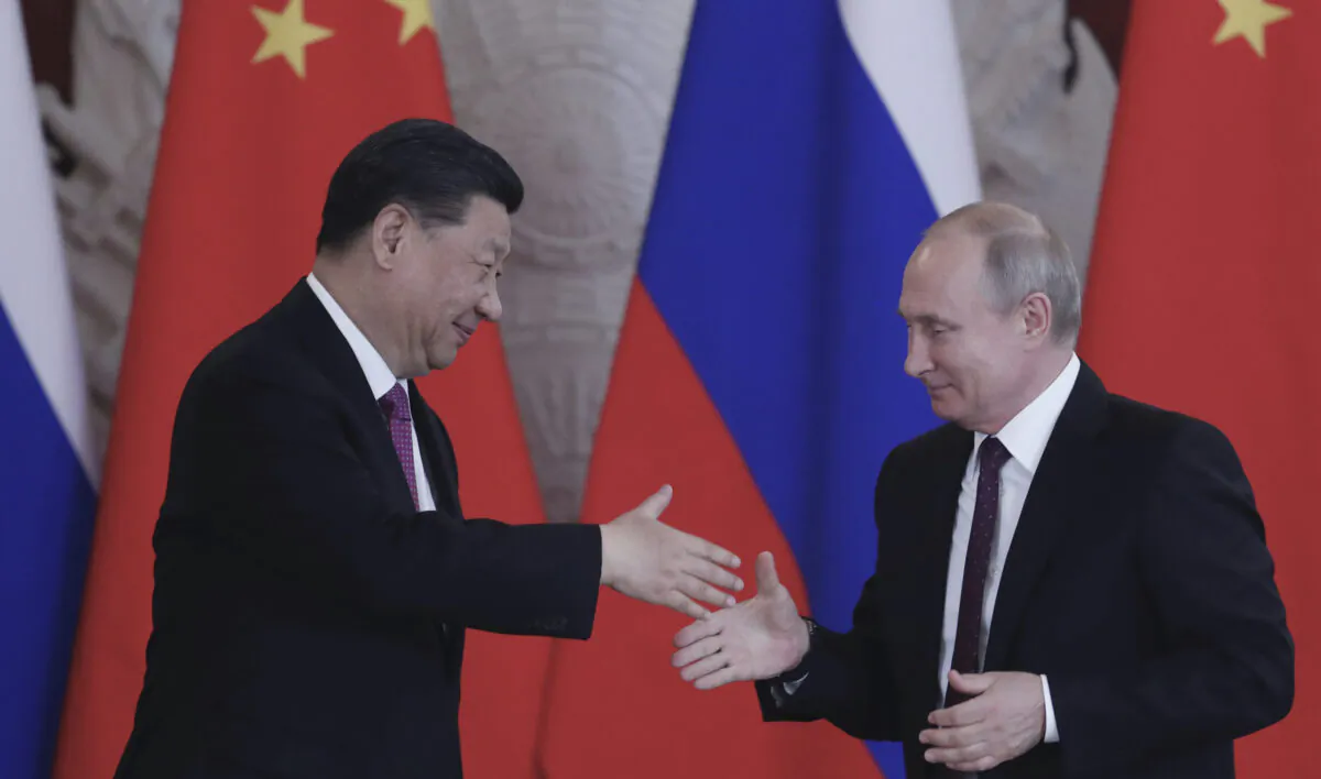 Russian President Vladimir Putin and Chinese leader Xi Jinping shake hands at the end of a joint press conference following their talks at the Kremlin on June 5, 2019. (Maxim Shipenkov/AFP via Getty Images)
