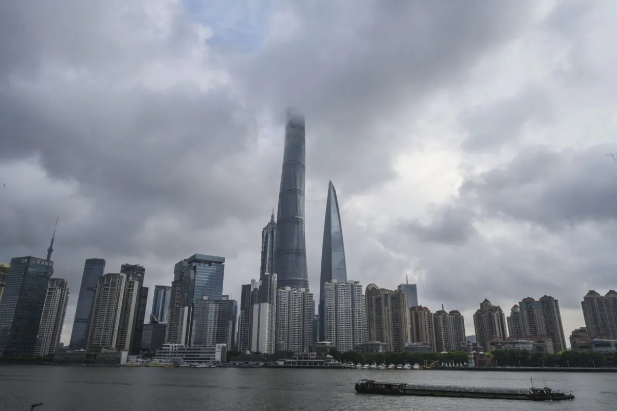 A boat travels on the Huangpu River as the skyline of the city is seen, including the Shanghai Tower on Aug. 28, 2020. (Kevin Frayer/Getty Images)