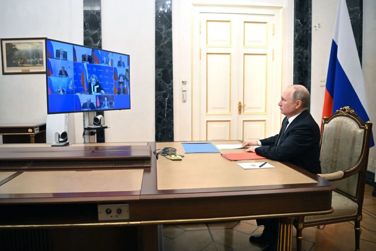 Russian President Vladimir Putin chairs a meeting with members of the Security Council via teleconference call at the Novo-Ogaryovo state residence outside Moscow, on Feb. 18, 2022. (Mikhail Klimentyev / Sputnik/AFP via Getty Images)