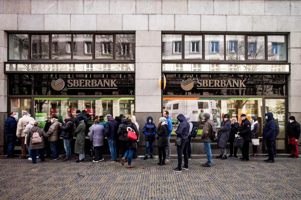 People queue outside a branch of the Russian state-owned bank Sberbank to withdraw their savings and close their accounts in Prague on Feb. 25, 2022, before Sberbank closed all its branches in the Czech Republic later in the day. (Michal Cizek/AFP via Getty Images)