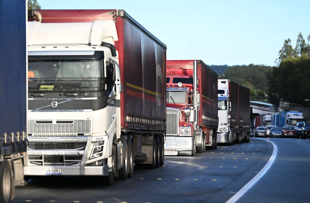Trucks are parked on the side of the closed M1 Pacific Motorway in Tweed Heads, Australia, on March 1, 2022. (Dan Peled/Getty Images)