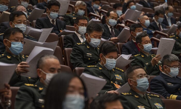 Attendees, many from the Chinese military, listen in the gallery at the opening session of the rubber-stamp legislature in Beijing, China, on March 5, 2022. (Kevin Frayer/Getty Images)