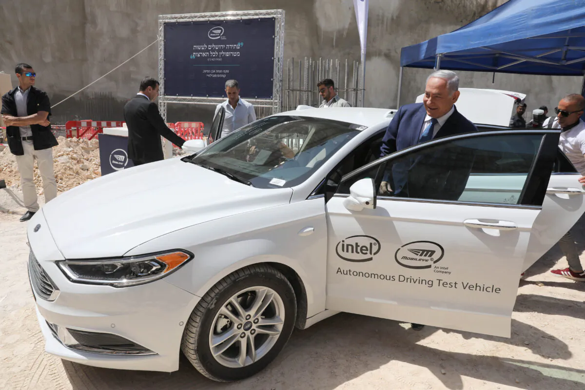 Israeli Prime Minister Benjamin Netanyahu boards an autonomous vehicle during a cornerstone ceremony for the Mobileye campus in Har Hahotzvim, northwest of Jerusalem on Aug. 27, 2019. (Abir Sultan/AFP via Getty Images)