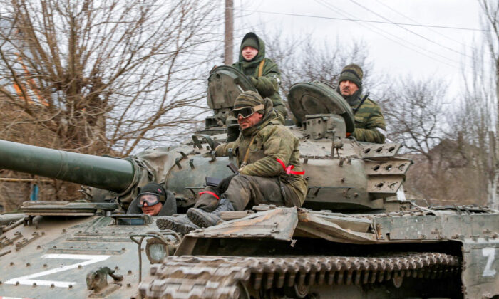Russian troops in uniforms without insignia are seen atop of a tank with the letter "Z" painted on its sides, in the Donetsk region, Ukraine, on March 1, 2022. (Alexander Ermochenko/Reuters)