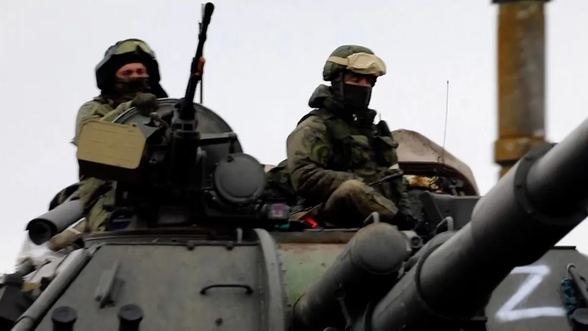 Various Russian military vehicles with "Z" marks, including self-propelled artillery and missile launchers, driving on a road. (Russian Defense Ministry Handout via AP/Screenshot via The Epoch Times)