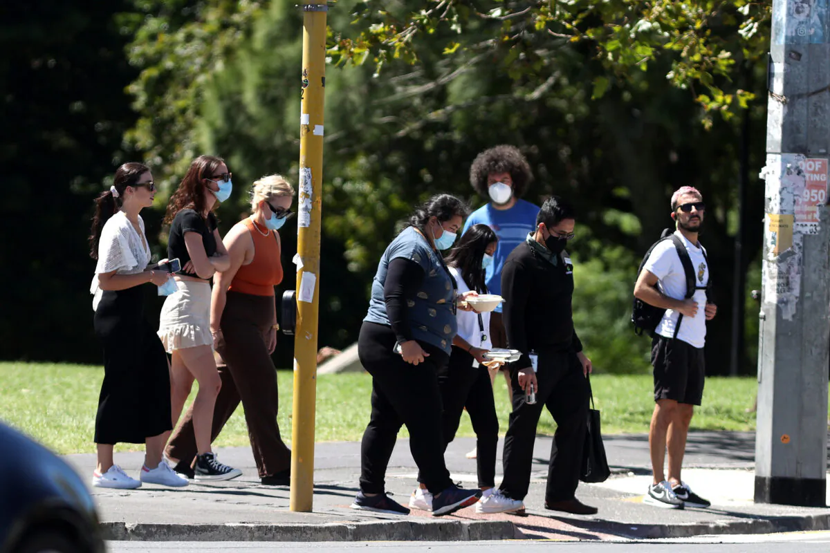 People walk in Auckland, New Zealand, on Feb. 15, 2022. (Phil Walter/Getty Images)