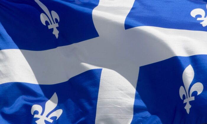 Quebec's provincial flag flies on a flagpole in a file photo. (The Canadian Press/Adrian Wyld
Adrian Wyld)